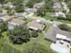 Aerial view of a residential neighborhood with houses, pools, and lush green spaces at 2098 Swan Ln, Safety Harbor, FL 34695