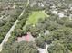 Aerial view of tennis courts and a park in a residential neighborhood at 2098 Swan Ln, Safety Harbor, FL 34695