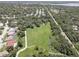 Aerial view of a large park and residential neighborhood near a body of water at 2098 Swan Ln, Safety Harbor, FL 34695