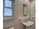 Small bathroom with pedestal sink and stained glass mirror at 2098 Swan Ln, Safety Harbor, FL 34695