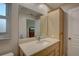 Bathroom with light wood vanity, updated sink and countertop at 2098 Swan Ln, Safety Harbor, FL 34695