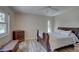 Bedroom with wooden sleigh bed, dresser, and hardwood floors at 2098 Swan Ln, Safety Harbor, FL 34695