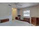 Bedroom with wooden sleigh bed, ceiling fan, and hardwood floors at 2098 Swan Ln, Safety Harbor, FL 34695