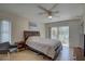 Bedroom with ceiling fan and sliding glass doors to backyard at 2098 Swan Ln, Safety Harbor, FL 34695