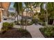 Backyard area with brick pavers, outdoor table and chairs, palm trees, and lush vegetation at 546 18Th Ne Ave, St Petersburg, FL 33704