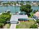 Aerial view of waterfront home with private dock and solar panels at 11600 7Th E St, Treasure Island, FL 33706