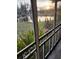View of a pond from a screened porch at sunset at 1401 W Spencer St, Plant City, FL 33563