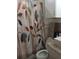 Bathroom with a shower/tub combo and decorative shower curtain at 1401 W Spencer St, Plant City, FL 33563