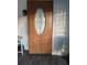 Wood front door with an oval glass insert at 1401 W Spencer St, Plant City, FL 33563