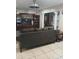 Living Room with large brown couch and wood entertainment center at 1401 W Spencer St, Plant City, FL 33563