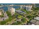 Aerial view of waterfront community with tennis courts and parking at 660 Island Way # 301, Clearwater Beach, FL 33767