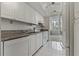 White kitchen with granite countertops and modern appliances at 660 Island Way # 301, Clearwater Beach, FL 33767