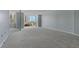 Spacious living room with large window and gray carpeting at 660 Island Way # 301, Clearwater Beach, FL 33767