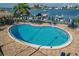 Kidney shaped pool with water and lounge chairs at 660 Island Way # 301, Clearwater Beach, FL 33767