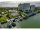 Aerial view of boat slips and waterfront property with lush landscaping at 660 Island Way # 301, Clearwater Beach, FL 33767