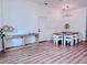 Bright dining room with modern light fixture and wood-look floors at 1768 Preston S St, St Petersburg, FL 33712