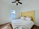 Main bedroom with yellow headboard and ceiling fan at 1768 Preston S St, St Petersburg, FL 33712