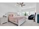 Large bedroom with king-size bed, ceiling fan, and private balcony access at 879 De Soto Way, Tarpon Springs, FL 34689