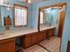 Double vanity bathroom with wood cabinets and tiled floors at 13201 Vonn Rd, Largo, FL 33774