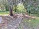 Stone pathway meandering through a shaded backyard at 13201 Vonn Rd, Largo, FL 33774