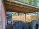 Covered storage area with gardening tools and tires at 13201 Vonn Rd, Largo, FL 33774