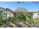 Landscaped front yard featuring a charming single-story home exterior at 253 Sunlit Cove Ne Dr, St Petersburg, FL 33702