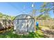 Functional storage shed in backyard, providing ample space for tools and outdoor equipment at 253 Sunlit Cove Ne Dr, St Petersburg, FL 33702