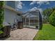 Landscaped backyard with a screened-in pool and patio at 4050 Eagle Cove East Dr, Palm Harbor, FL 34685