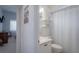 Clean bathroom with shower, toilet, and floating shelves at 4050 Eagle Cove East Dr, Palm Harbor, FL 34685