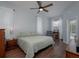 Spacious bedroom with king-size bed, ceiling fan, and access to the pool at 4050 Eagle Cove East Dr, Palm Harbor, FL 34685