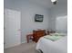 Bright bedroom with a comfortable bed, dresser, and TV at 4050 Eagle Cove East Dr, Palm Harbor, FL 34685