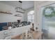 Bright dining room with a wooden table, gray chairs, and a stylish chandelier at 4050 Eagle Cove East Dr, Palm Harbor, FL 34685