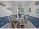 Spacious dining room featuring a wooden table, gray chairs, and an elegant chandelier at 4050 Eagle Cove East Dr, Palm Harbor, FL 34685