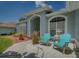 Home's exterior features a welcoming front porch with stylish seating at 4050 Eagle Cove East Dr, Palm Harbor, FL 34685