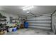 Garage with storage shelves and large door at 4050 Eagle Cove East Dr, Palm Harbor, FL 34685