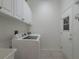 Bright laundry room with washer, dryer, and cabinets at 4050 Eagle Cove East Dr, Palm Harbor, FL 34685