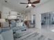 Bright living room with open concept to kitchen, featuring comfortable seating and access to patio at 4050 Eagle Cove East Dr, Palm Harbor, FL 34685