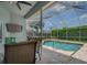 Inviting pool area with screened enclosure and patio furniture at 4050 Eagle Cove East Dr, Palm Harbor, FL 34685