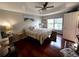 Bright bedroom with wood floors, ceiling fan, and ample natural light at 6546 Marlberry Way, Largo, FL 33773