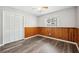 Cozy bedroom featuring stylish accents, wood paneling, hard surface floors and a ceiling fan at 1549 Linwood Dr, Clearwater, FL 33755