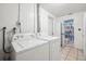 Well-lit laundry room with a washer, dryer, storage space, and access to a bathroom at 1549 Linwood Dr, Clearwater, FL 33755