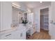 Double vanity bathroom with marble countertop and walk-in closet at 2 4Th Ave, Indian Rocks Beach, FL 33785