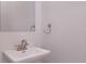 Simple bathroom with pedestal sink and mirror at 2 4Th Ave, Indian Rocks Beach, FL 33785