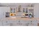 White kitchen with marble island and stainless steel appliances at 2 4Th Ave, Indian Rocks Beach, FL 33785