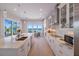 Modern white kitchen with marble countertops and ocean view at 2 4Th Ave, Indian Rocks Beach, FL 33785