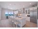 Modern white kitchen with marble island and stainless steel appliances at 2 4Th Ave, Indian Rocks Beach, FL 33785