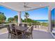 Covered deck with ocean views, dining table, and seating for six at 2 4Th Ave, Indian Rocks Beach, FL 33785