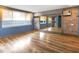 Studio with brick accent wall, wood floors, and large mirror at 4822 3Rd S Ave, St Petersburg, FL 33711