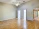 Open living room with ceiling fan and hardwood floors at 1171 Clays Trl, Oldsmar, FL 34677