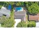 Aerial view of house, pool, and surrounding trees at 12912 Willoughby Ln, Hudson, FL 34667